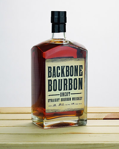 Backbone Bourbon Uncut Bottle sitting on wooden box